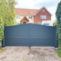 This bespoke aluminium driveway gate was created with a bell curved top and installed at a property in Caldy, Wirral.