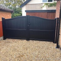 A black, bespoke, aluminium driveway gate created with a vertical solid infill and fitted at a property in Heskin, Chorley.