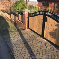 A bespoke hardwood, timber infill driveway gate with matching wall panels, installed at a property in Bolton, Blackrod.3