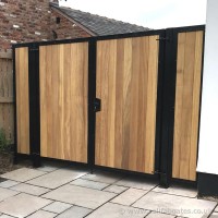 A powder coated, steel frame driveway gate with timber infills, fitted with matching side panels at a property near Preston.