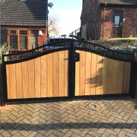 A galvanised steel frame driveway gate with iroko hardwood infill, installed at a property in Bolton.