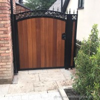 An arch top, steel frame garden gate, installed with matching side panels at a property in Addlington near Bolton.