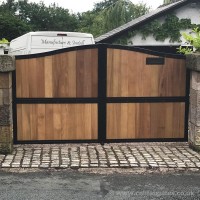 An installation in Cheshire for a bespoke galvanised steel driveway gate with timber infill and ornate letterbox.