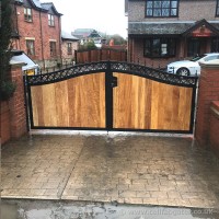 Ornate iron and steel driveway gate with timber infill, fitted at a client’s home in Hindley, Wigan.