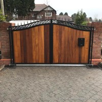 An installation at a property in Manchester of a bespoke steel and wood driveway gate with a custom letter box.